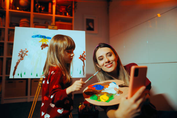 istock Mother and Daughter Taking a Selfie While Painting Together 1812562438