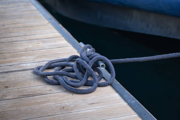 istock rope and cleat on wooden pier. 1812598621
