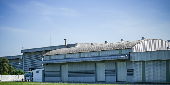 ฺฺBuilding and steel structure factory with the blue sky, The roof of the factory.