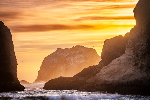 Warm morning light falls on the sea stacks of Oregon's Bandon Beach