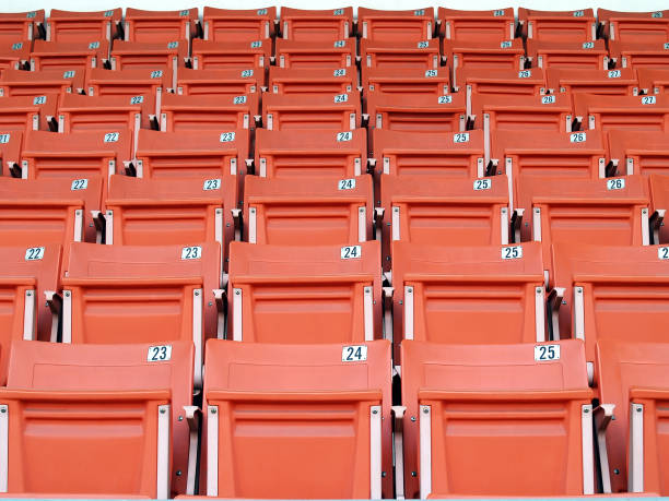 istock empty orange stadium grandstand seats with seat label number 1812691189