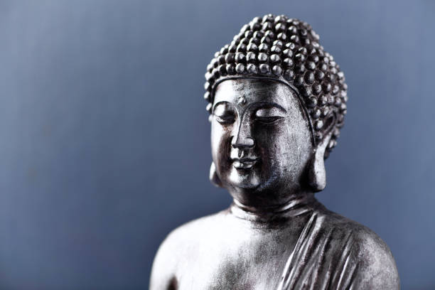 istock Meditating Buddha Statue on dark background. Close up. Copy space. 1812706589