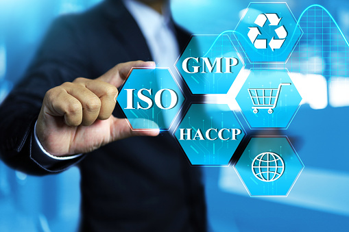 Food safety standard concept with businessman hold on ISO icon to verified or warranty security of food to human eat by GMP and HACCP mark for international standardization