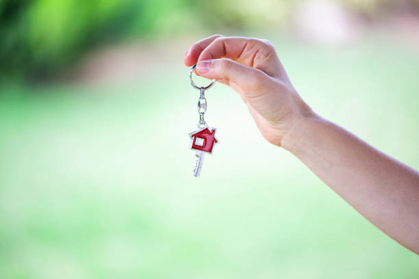 istock Woman hand holding house key. 1812749846