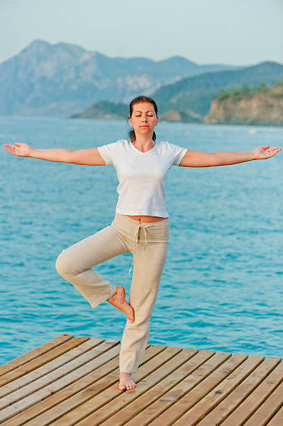istock girl by holding a balance while standing on one leg 181275727
