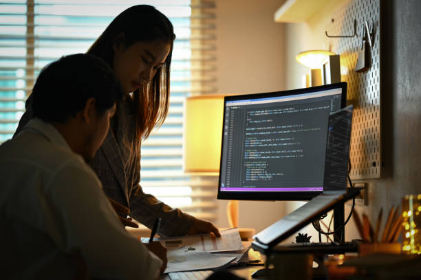 istock Two young colleagues discussing and working on Artificial Intelligence project at home office 1812821436