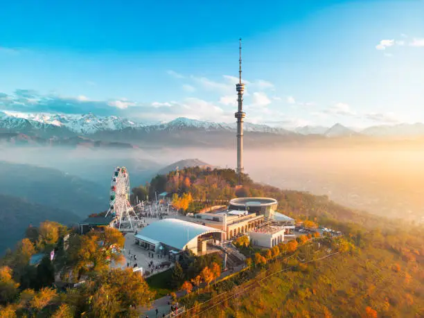 Aerial view of Kok-Tobe hill with Television Tower and amusement park in Almaty city