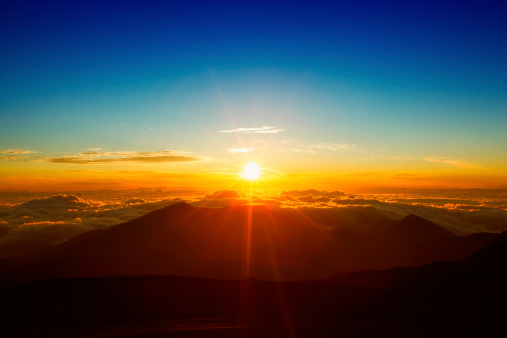 Beautiful sunrise from above the clouds of Haleakala National Park in Maui.