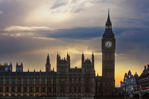 The iconic Clock Tower, known globally as Big Ben, stands proudly amidst the enchanting cityscape of London, England. This architectural masterpiece, situated in the heart of the City of Westminster, is a symbol of British culture and history. Illuminated against the backdrop of a vibrant sunset, the tower graces the urban skyline, captivating all who gaze upon it.