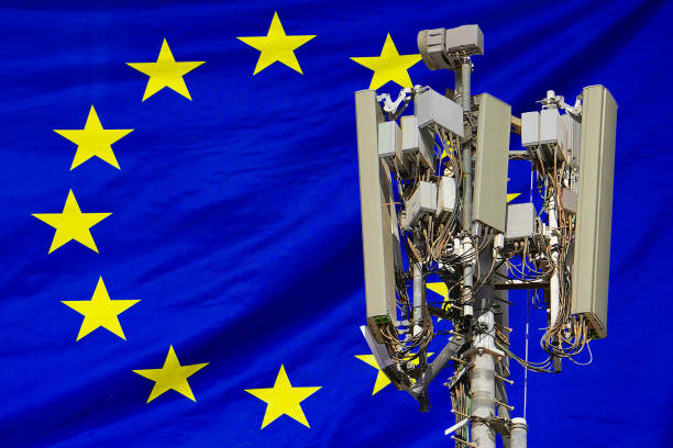 5G network antenna base station on background EU flag. 6G network antenna base station on telecom tower emitting signal