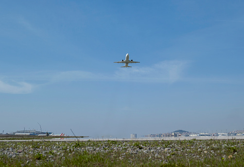 Commercial airplane flying over bright blue sky and white clouds. Elegant Design with copy space for travel concept