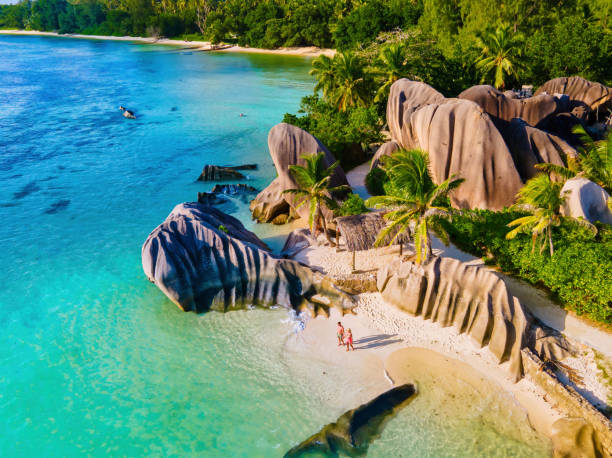 istock Anse Source d'Argent beach, La Digue Island, Seyshelles, Drone aerial view of La Digue Seychelles bird eye view, couple men and woman walking at the beach during sunset at a luxury vacation 1812905795