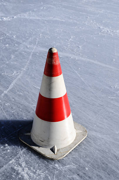 istock red white striped cones on the ice rink 181291017