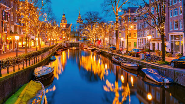 istock Amsterdam Netherlands canals with christmas lights during Decemb 1812910771