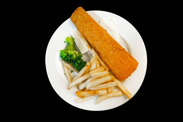 Top view of french fried with fried fish on black background.