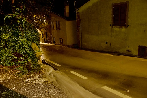 Flooding on the streets of a small town at night