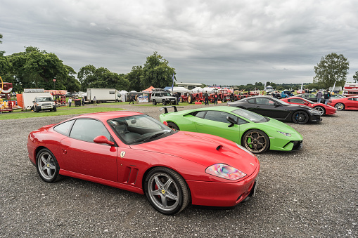 Tarporley, Cheshire, England, July 30th 2023. Red Ferrari 575M and green Lamborghini Huracan Performante at a supercar meet.