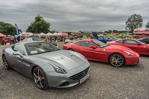 Tarporley, Cheshire, England, July 30th 2023. Silver and red Ferrari California at a supercar meet, automotive lifestyle editorial illustration.