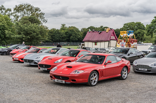 Tarporley, Cheshire, England, July 30th 2023. Row of red and silver Ferrari's at a supercar meet, automotive lifestyle editorial illustration.