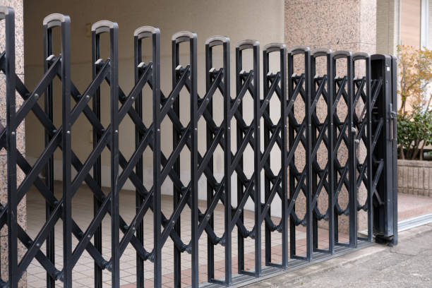A black expandable gate across a driveway