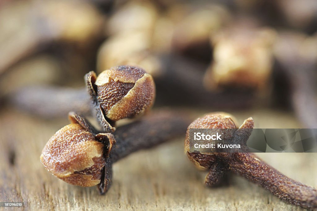 Cloves closeup Dry clove closeup on wooden background African Culture Stock Photo