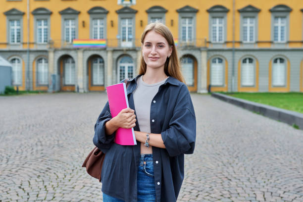 istock Young girl student posing outdoors, background of educational building 1812969856