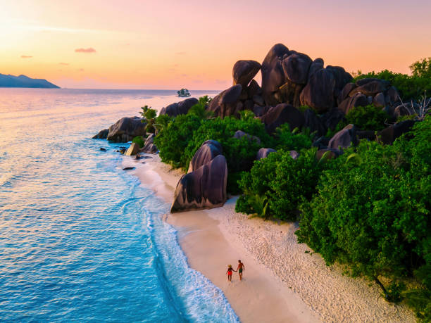 istock Anse Source d'Argent beach, La Digue Island, Seyshelles, Drone aerial view of La Digue Seychelles bird eye view, couple men and woman walking at the beach during sunset at a luxury vacation 1812974367