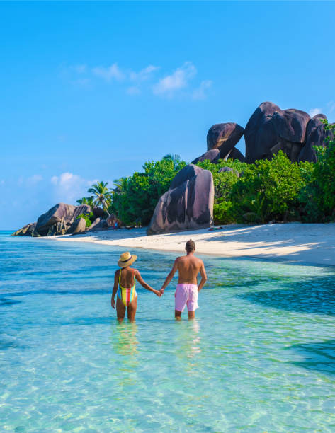 istock Anse Source d'Argent beach, La Digue Island, Seyshelles, Drone aerial view of La Digue Seychelles bird eye view, couple men and woman walking at the beach during sunset at a luxury vacation 1812974635