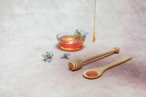 istock honey dripping on a wooden spoon 1812974897
