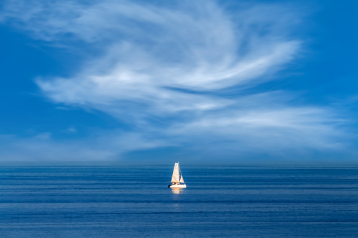 A sailing boat in the open and calm Mediterranean Sea.