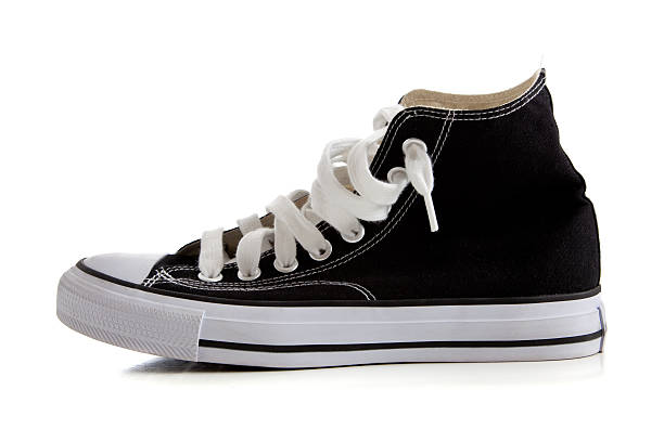 Black high top sneakers on white Black canvas high top sneakers or tennis shoes on a white background high tops stock pictures, royalty-free photos & images