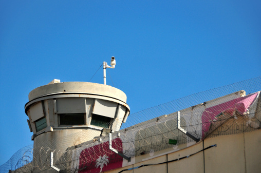 Jerusalem, Israel: Israeli Defense Forces (IDF) sentry tower with surveillance cameras and barbed wire at Rachel's Tomb Crossing Checkpoint - watch tower near Bethlehem, part of the Israeli West Bank barrier, security fence made of concrete slabs - photo by M.Torres
