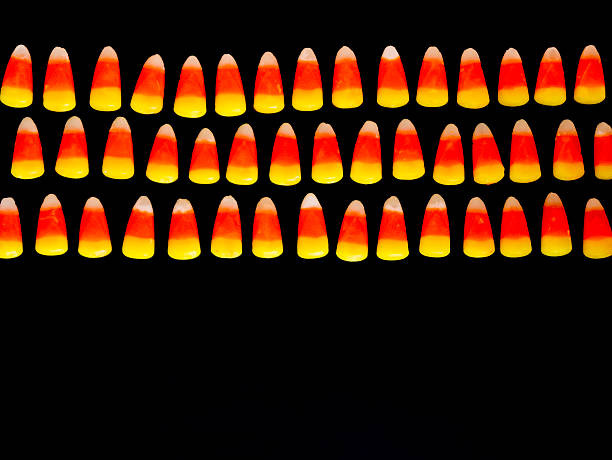 Rows of Candy Corn on Black stock photo