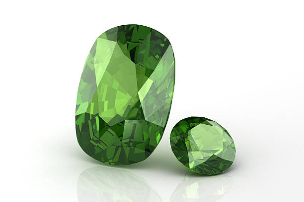 2 peridot jewels on white surface with slight reflection Peridot garnet stock pictures, royalty-free photos & images
