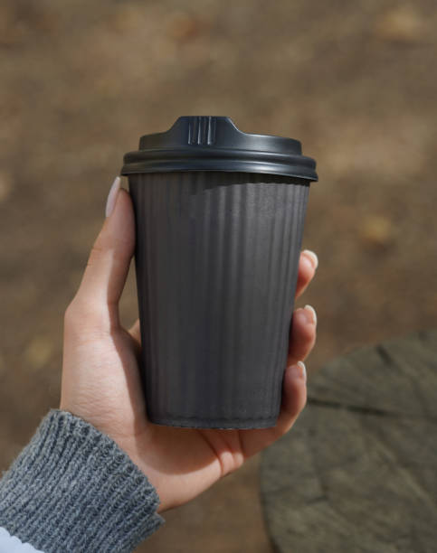 istock Woman Holding a Paper coffee Cup in Hand. 1813028322