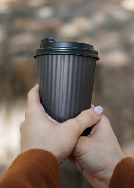 istock Woman Holding a Paper coffee Cup in Hand. 1813028324