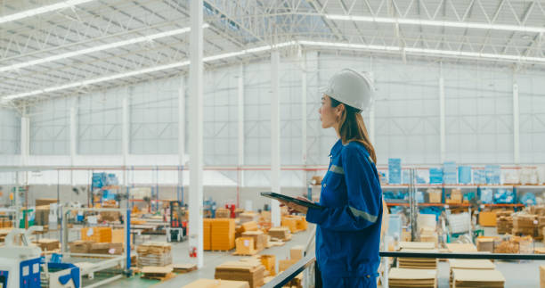 istock Professional Asian female industrial engineers use tablet while standing in manufacturing factory. Working in manufacturing plant or production plant. 1813062663