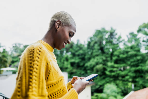 istock Young woman using the mobile phone at home 1813068788