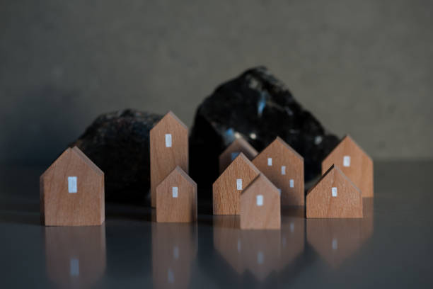 Miniature houses on grey background. Real estate concept with copyspace on the top