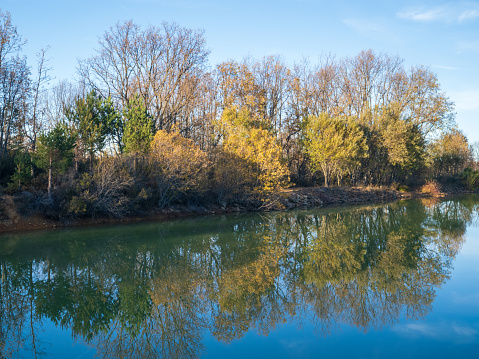 Ostheim natural bathing lake near Malsfeld. Idyllic landscape by the lake in autumn.