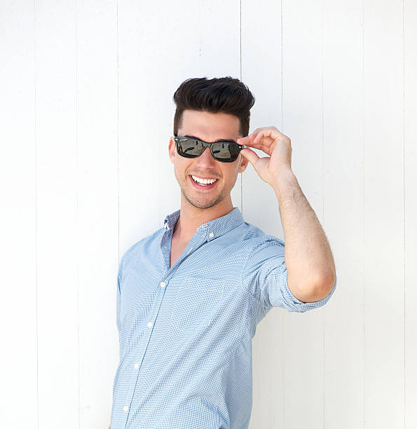 istock Happy young man smiling with sunglasses 181310195