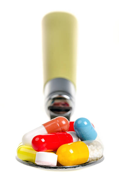 Tablets and the pills on a spoon stock photo