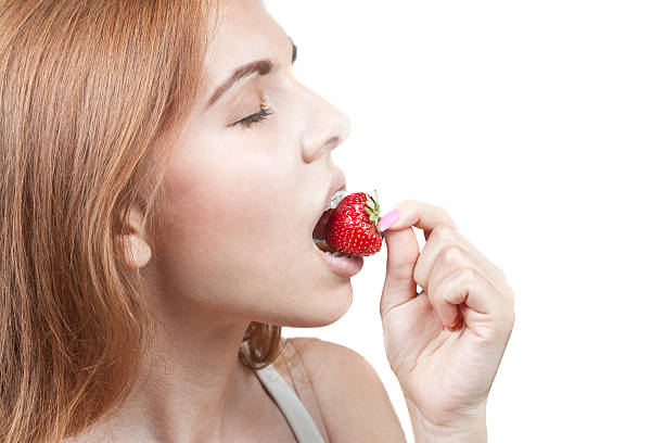 istock Girl eating a strawberry 181310587