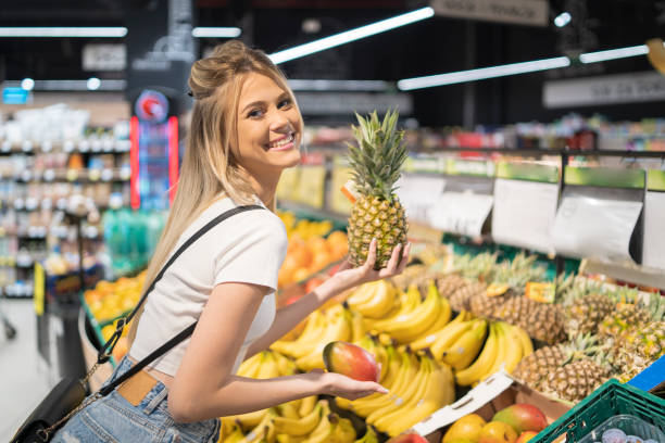 istock Young blonde woman chooses fruit 1813109608