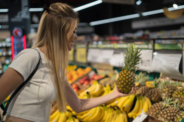 istock Young blonde woman chooses fruit 1813110122
