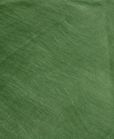 Blank green fabric texture as background. Empty textile backdrop photo.