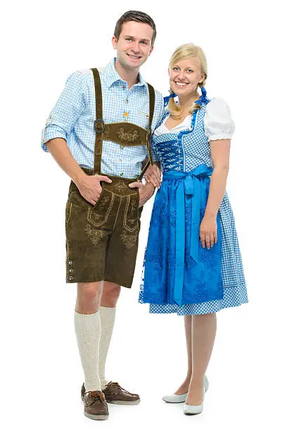 beautiful couple in traditional bavarian tracht  standing. Isolated on white background