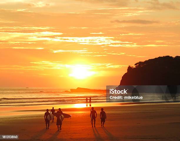 Surfers And Beach Goers Gaze At The Golden Orange Sunset Stock Photo - Download Image Now