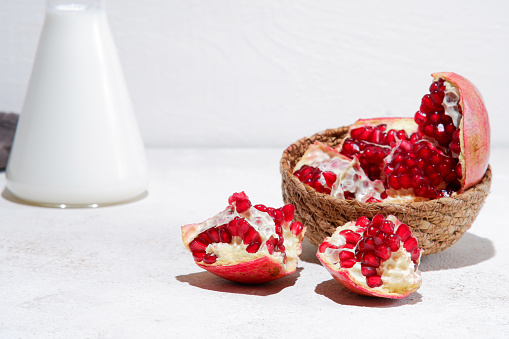 whole and part of Pomegranate with leaves isolated on white