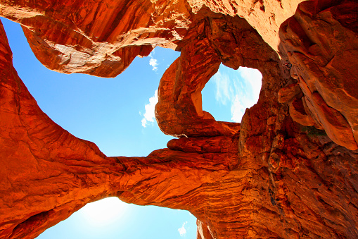 Stock photograph of the landmark Turret Arch as seen through North Window in Arches National Park, Utah, USA during sunrise.